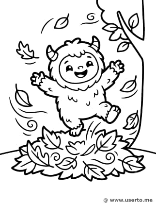 Pequeño yeti jugando en las hojas de otoño